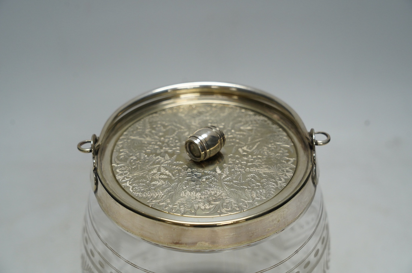 An electroplate mounted glass biscuit barrel, 16cm. Condition - fair to good